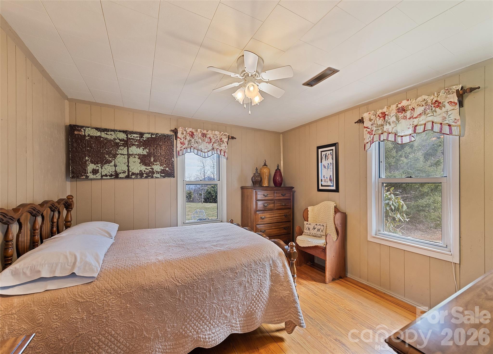 15 Whitted Road Canton, NC 28716 - Photo 17 of 38 a bedroom with a large bed a chandelier and a window