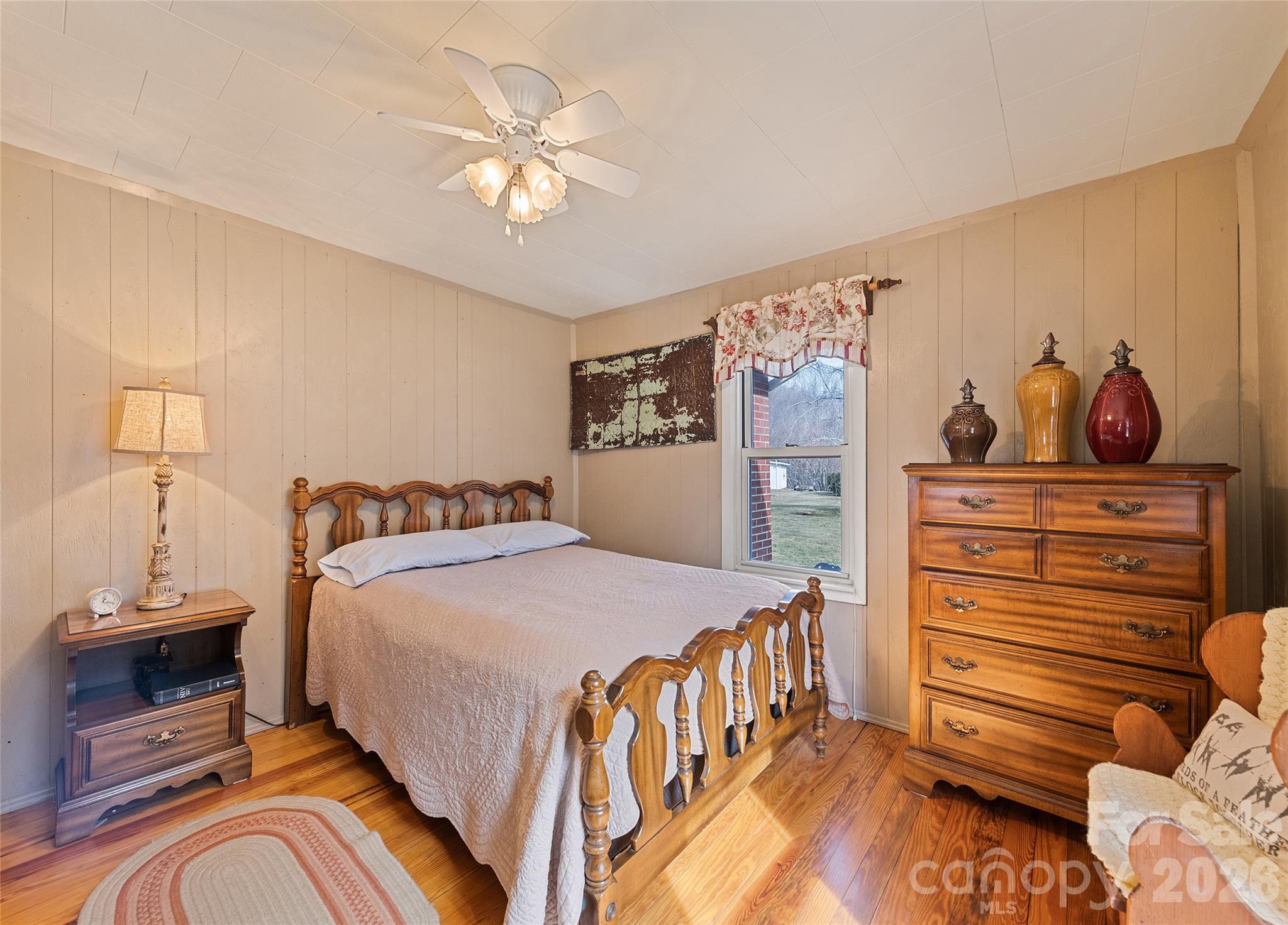 15 Whitted Road Canton, NC 28716 - Photo 18 of 38 a bedroom with a bed and wooden floor