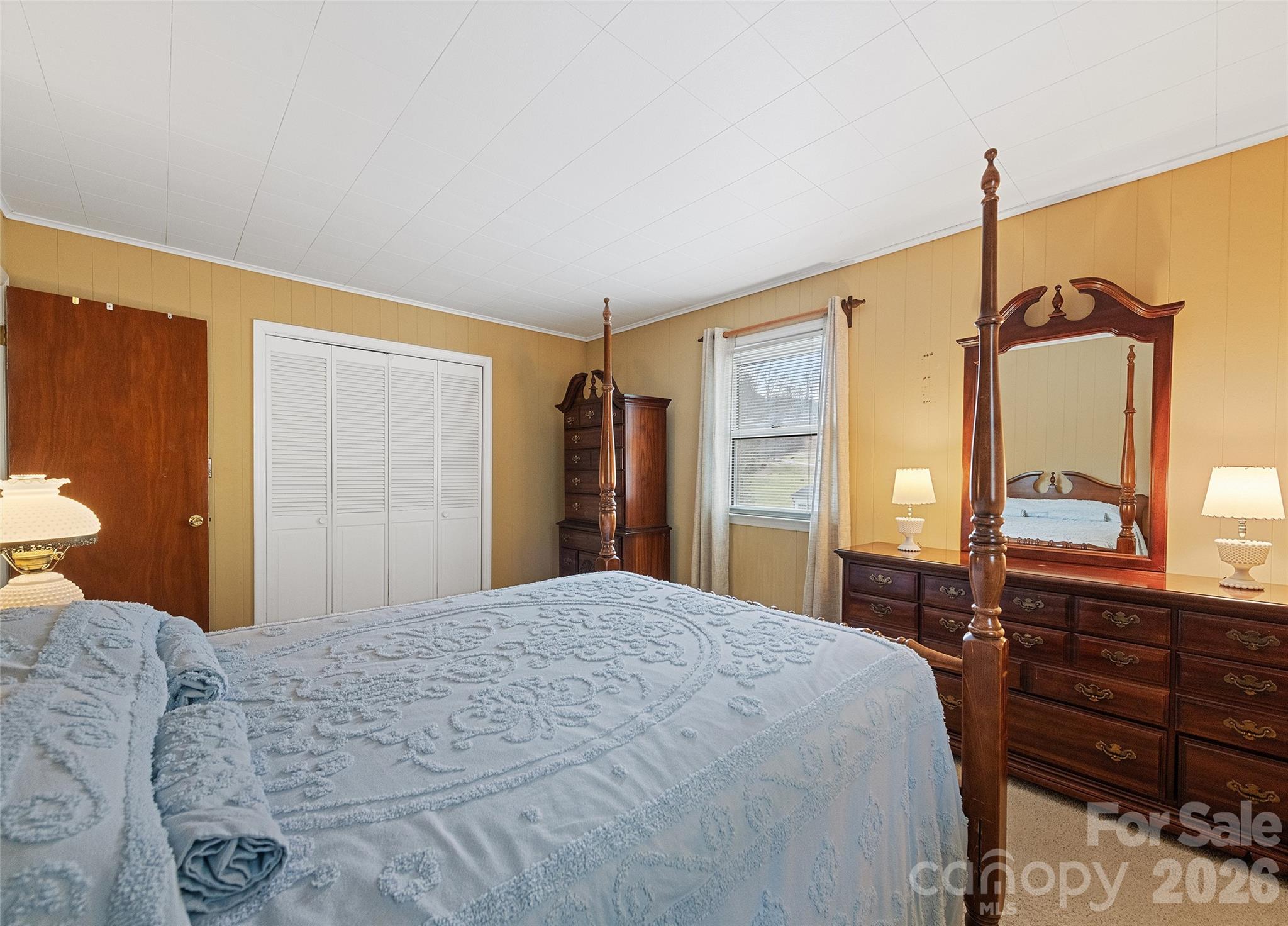 15 Whitted Road Canton, NC 28716 - Photo 24 of 38 a bedroom with a bed dresser and a large mirror