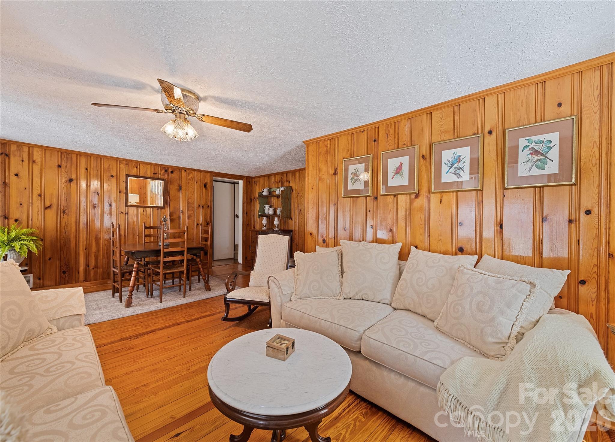 15 Whitted Road Canton, NC 28716 - Photo 8 of 38 a living room with furniture a wooden floor and chandelier
