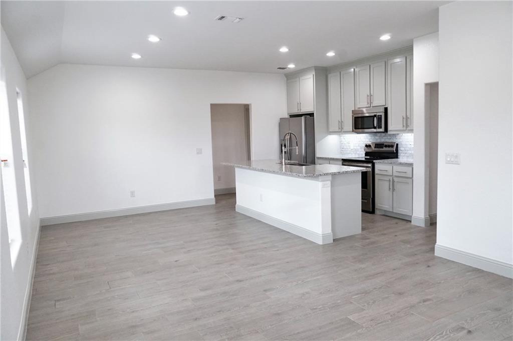 424 East Nelson Street Denison, TX 75021 - Photo 21 of 21 a kitchen with stainless steel appliances a refrigerator sink and microwave