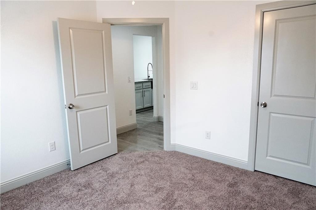 424 East Nelson Street Denison, TX 75021 - Photo 5 of 21 an empty room with a door