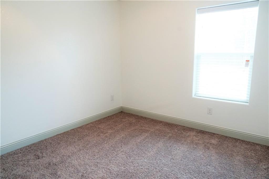 424 East Nelson Street Denison, TX 75021 - Photo 8 of 21 an empty room with a window