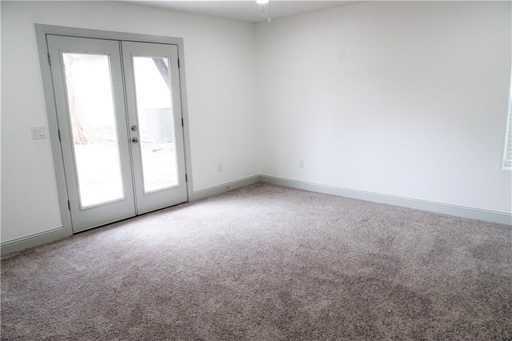 424 East Nelson Street Denison, TX 75021 - Photo 9 of 21 an empty room with windows