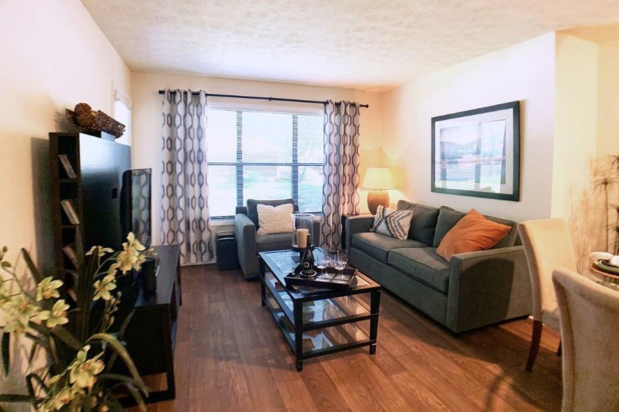 3450 K Jones Mill Road, Unit 218 Norcross, GA 30092 - Photo 7 of 29 a living room with furniture a large window and a flat screen tv