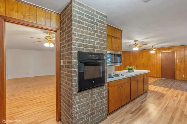 a kitchen with stainless steel appliances granite countertop a sink and a refrigerator