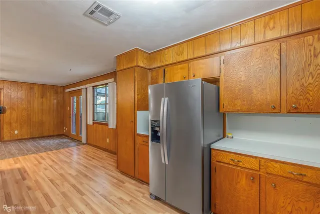 a view of a refrigerator in kitchen and wooden floor