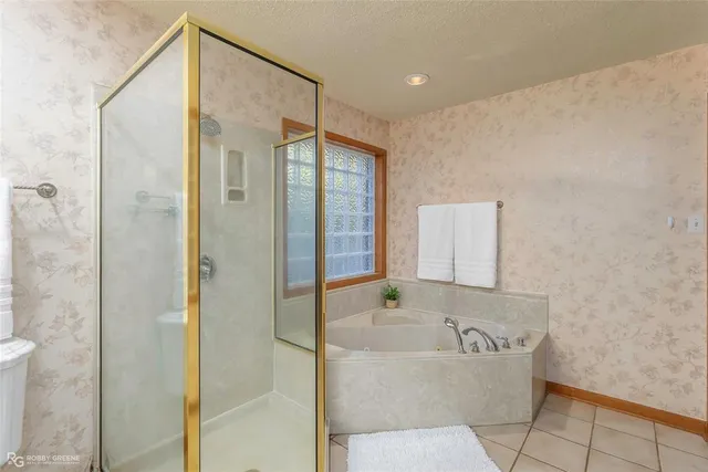 a bathroom with a bathtub and shower