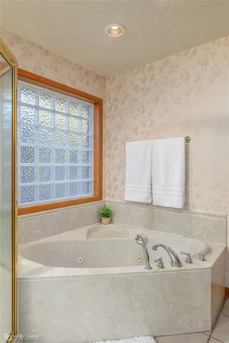 a white bath tub sitting next to a window