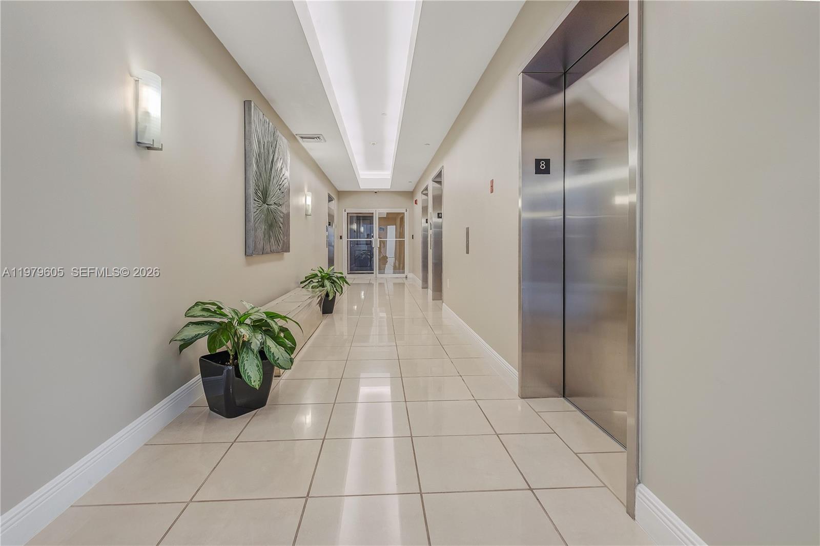 1250 South Miami Avenue, Unit 2802 Miami, FL 33130 - Photo 39 of 64 a hallway with painting and a potted plant