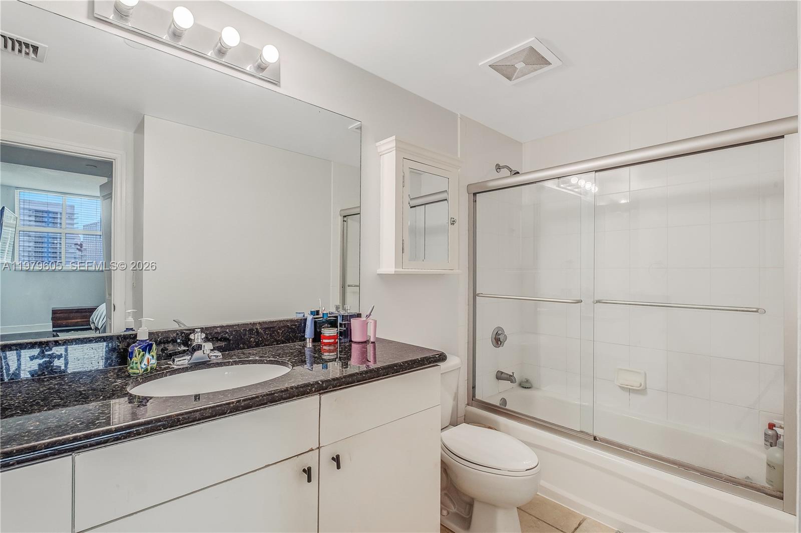 1250 South Miami Avenue, Unit 2802 Miami, FL 33130 - Photo 50 of 64 a bathroom with a granite countertop sink a toilet and shower