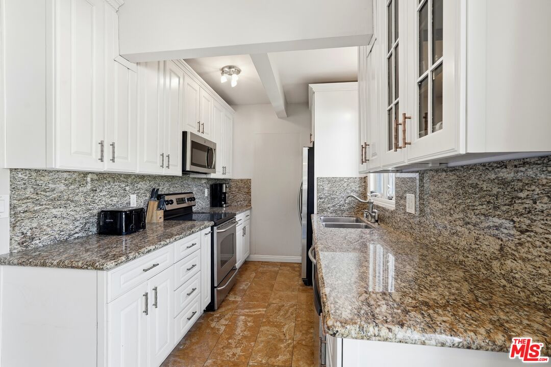 2955 Corral Canyon Road Malibu, CA 90265 - Photo 8 of 21 a kitchen with granite countertop a sink stove and cabinets