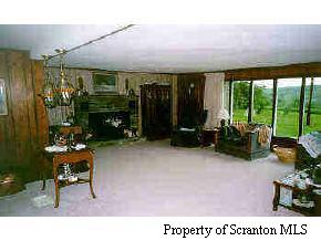 0 Meshopany Ridge Road Meshoppen, PA 18630 - Photo 5 of 7 a living room with furniture a floor to ceiling window and a table