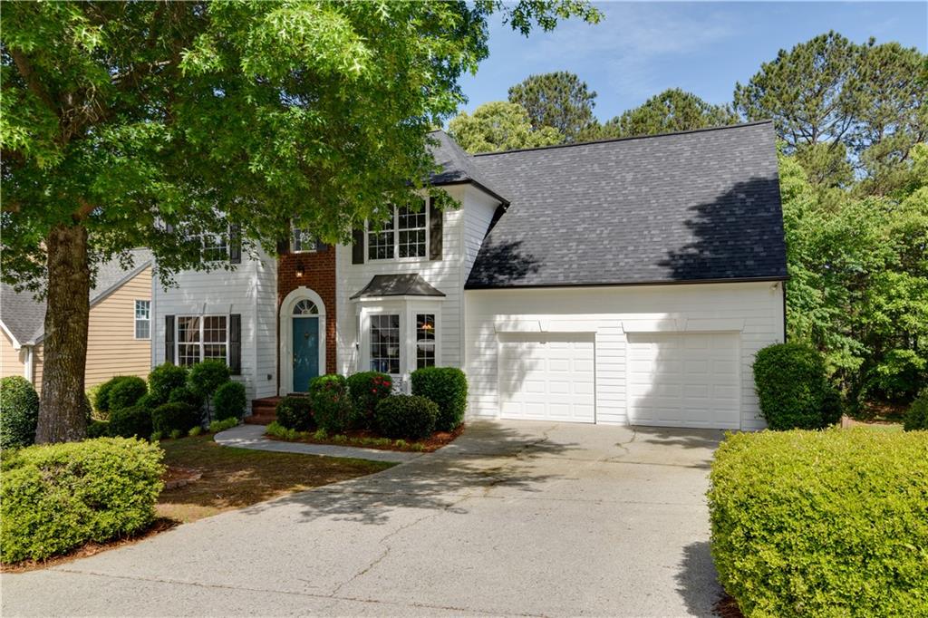 a front view of a house with a yard and a garage