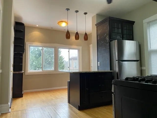 a kitchen with stainless steel appliances granite countertop a refrigerator and a sink