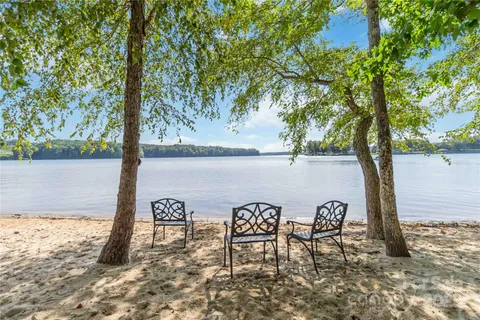 a view of a lake with table and chairs