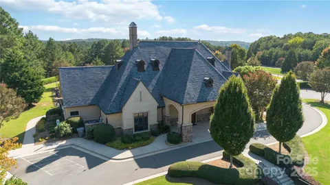 an aerial view of a house with a yard and potted plants