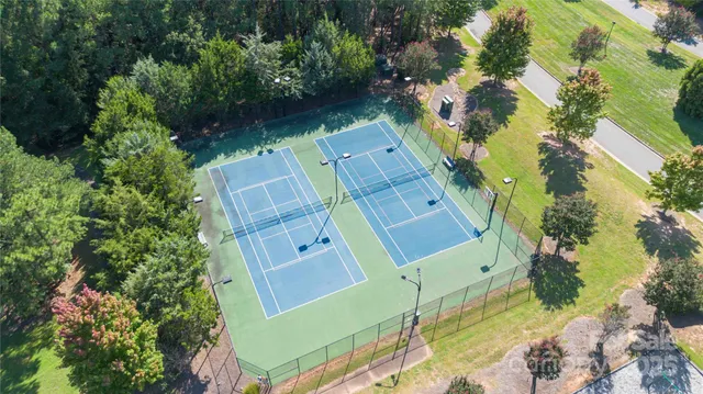 an aerial view of a house with a yard lake and outdoor seating