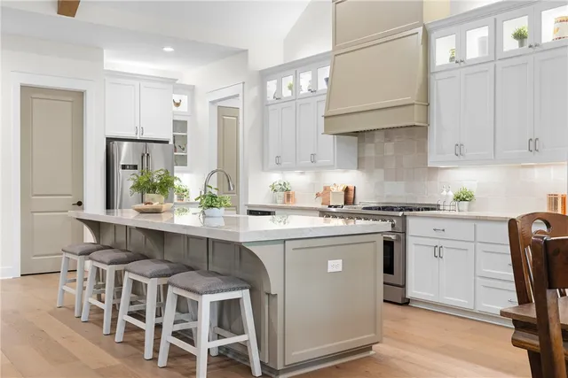 a kitchen with granite countertop white cabinets and chairs
