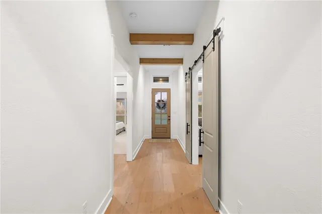 a view of a hallway with wooden floor