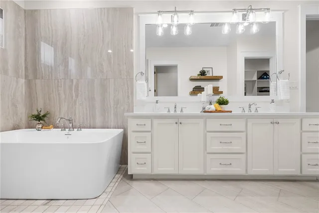 a bathroom with a bathtub sink and mirror