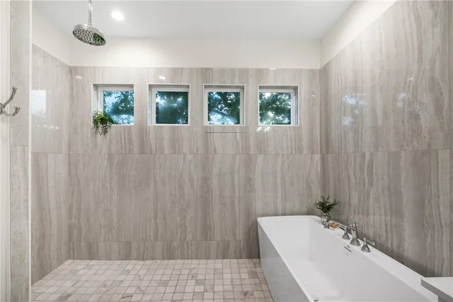 a bathroom with a bathtub and shower