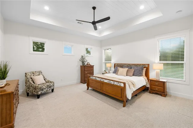 a spacious bedroom with a bed and a window