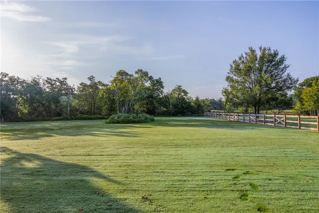a view of a swimming pool with a yard