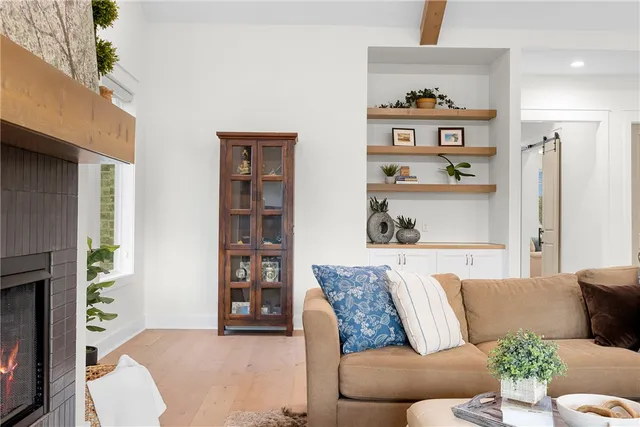 a living room with furniture and painting on the wall