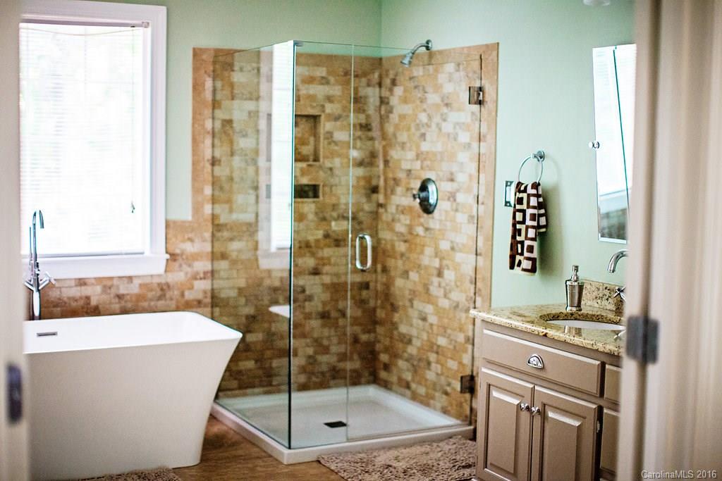 12521 Hawks Ridge Road Huntersville, NC 28078 - Photo 12 of 24 a bathroom with a bathtub and a shower