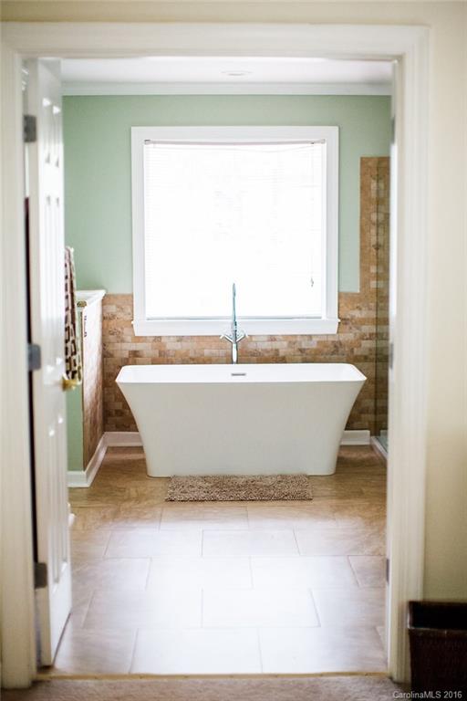 12521 Hawks Ridge Road Huntersville, NC 28078 - Photo 13 of 24 a white bath tub sitting in a bathroom