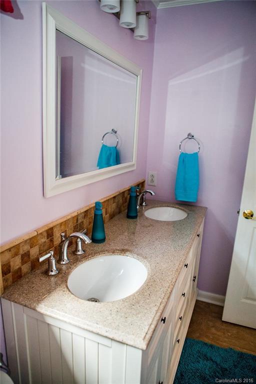 12521 Hawks Ridge Road Huntersville, NC 28078 - Photo 17 of 24 a bathroom with a granite countertop sink a mirror and vanity