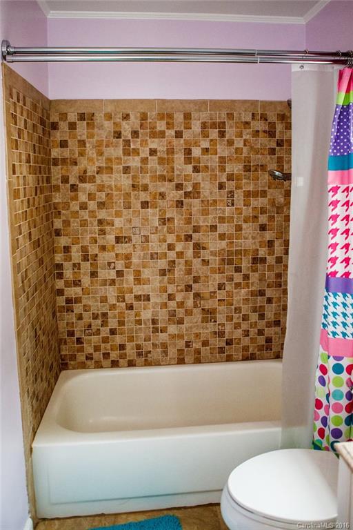 12521 Hawks Ridge Road Huntersville, NC 28078 - Photo 18 of 24 a bathroom with a bathtub and a shower curtain