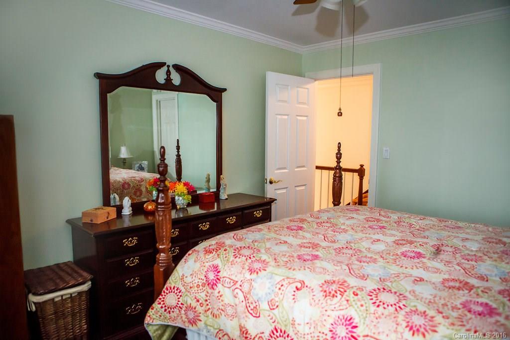 12521 Hawks Ridge Road Huntersville, NC 28078 - Photo 20 of 24 a bedroom with a bed and a chandelier