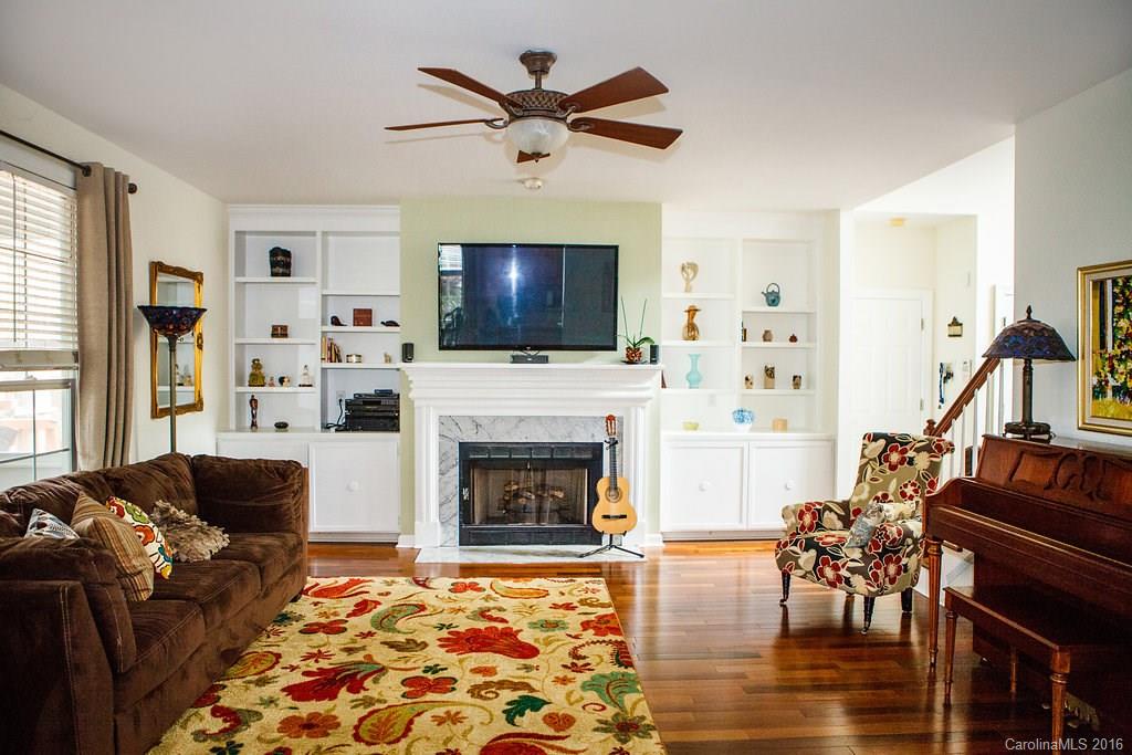 12521 Hawks Ridge Road Huntersville, NC 28078 - Photo 5 of 24 a living room with furniture a flat screen tv and a fireplace