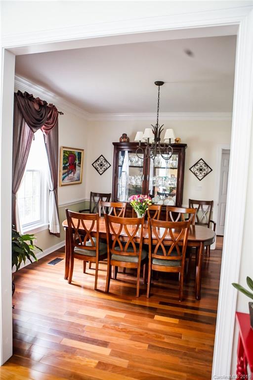 12521 Hawks Ridge Road Huntersville, NC 28078 - Photo 8 of 24 a view of a dining room with furniture and wooden floor