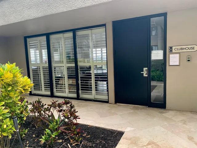 a view of a patio with couches table and chairs and potted plants