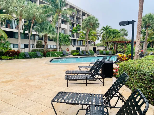a view of house with outdoor seating and yard