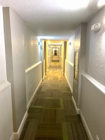 a bedroom with furniture and large windows