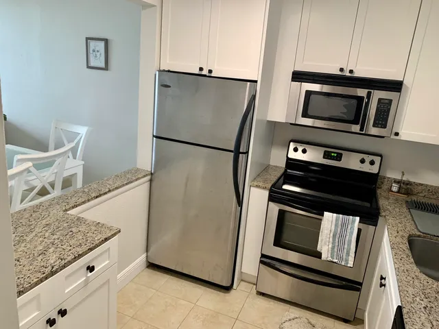 a kitchen with granite countertop a stove top oven and sink