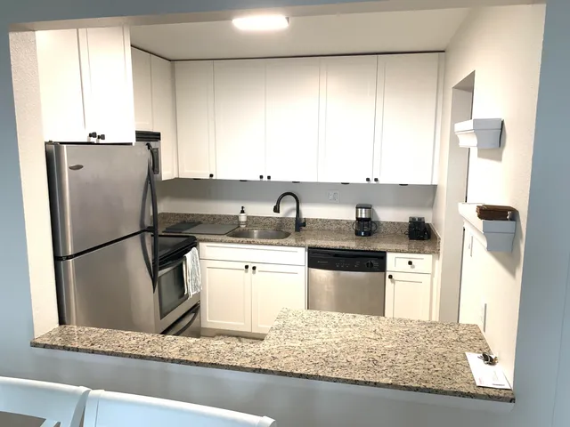 a kitchen with a table chairs and a stove