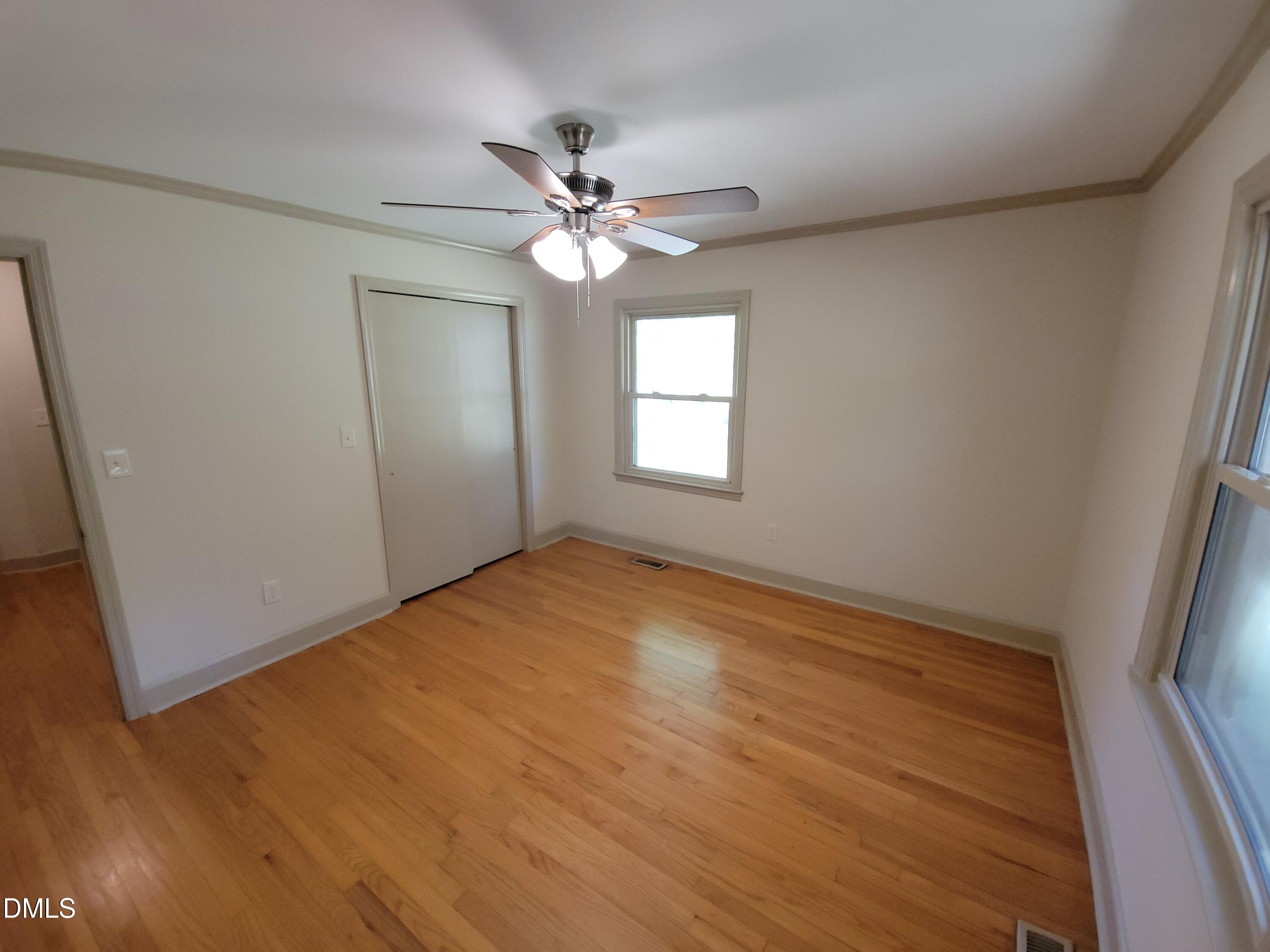 7000 Holly Springs Road Raleigh, NC 27606 - Photo 19 of 24 wooden floor in an empty room with a window