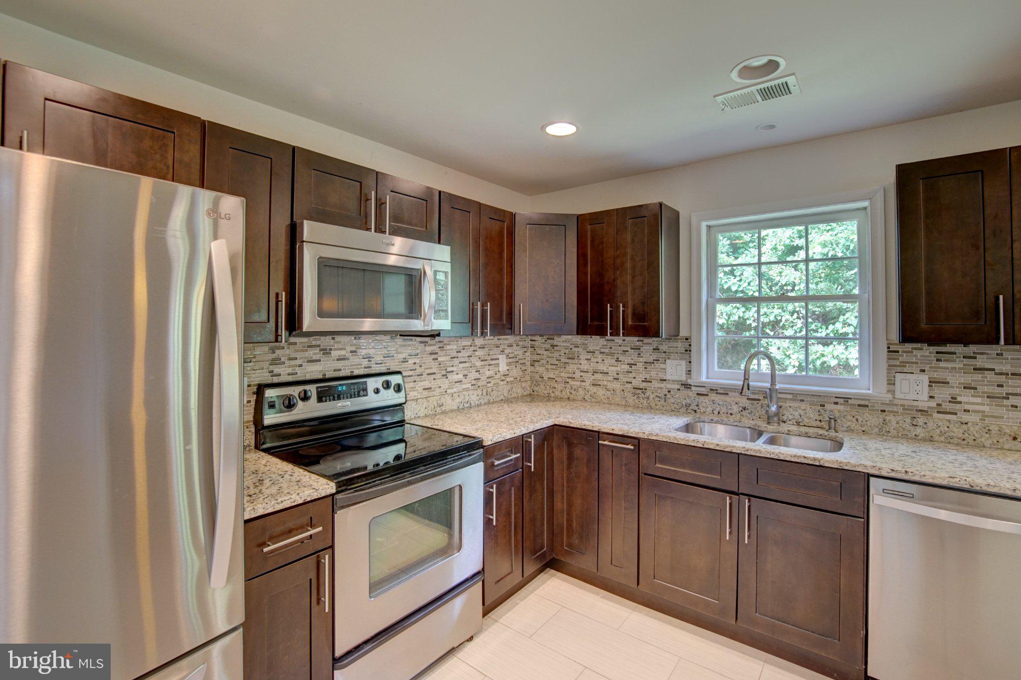 900 Walker Road Great Falls, VA 22066 - Photo 12 of 52 Modern kitchen with sleek finishes.