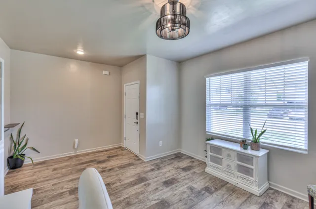 a bathroom with a granite countertop sink a toilet and a mirror