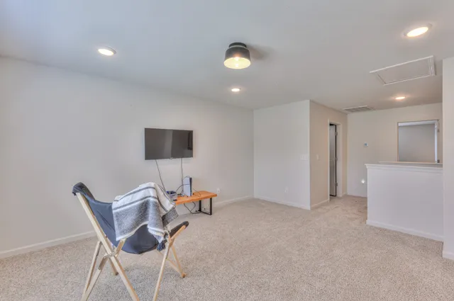 a view of walk in closet with clothes