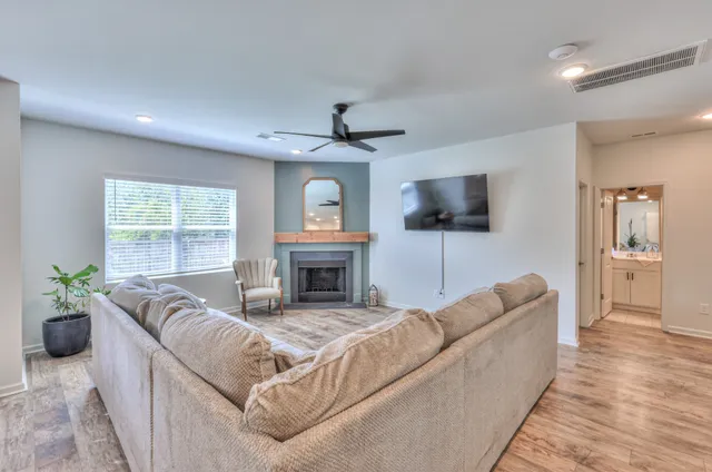 a living room with furniture a dining table and chairs