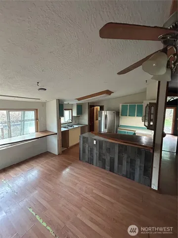 a view of a living room with furniture and window