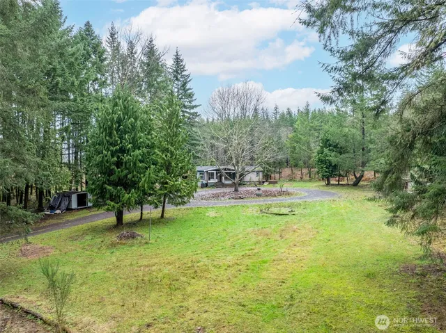 a swimming pool with outdoor seating and trees