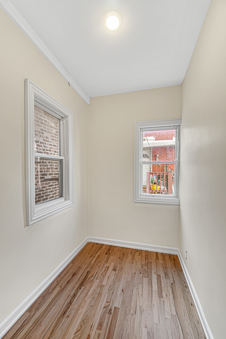 2623 West 21st Place Chicago, IL 60608 - Photo 12 of 29 a view of an empty room with wooden floor and a window