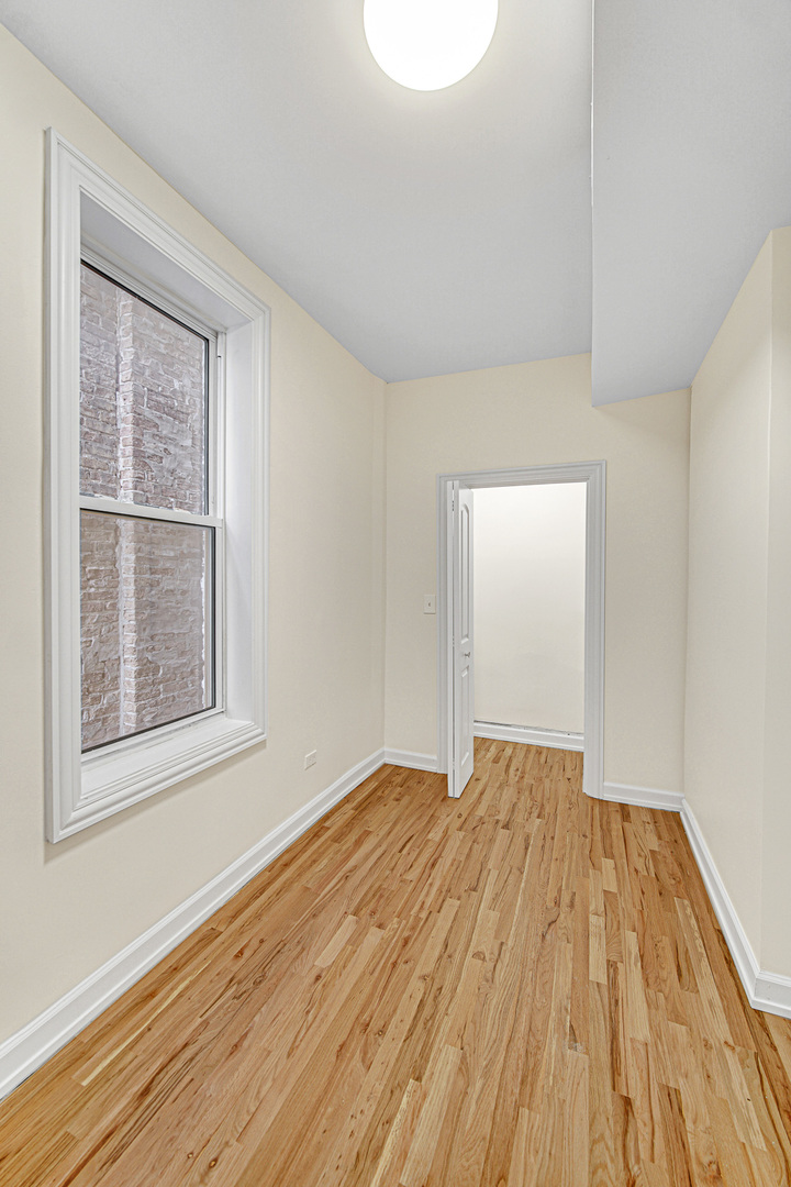 2623 West 21st Place Chicago, IL 60608 - Photo 14 of 29 a view of an empty room with wooden floor and a window